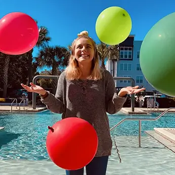 young woman surrounded by balloons